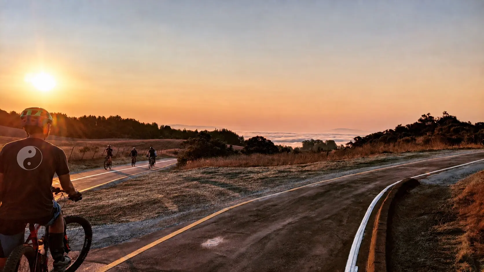 Mountain bikers riding at sunset above Santa Cruz