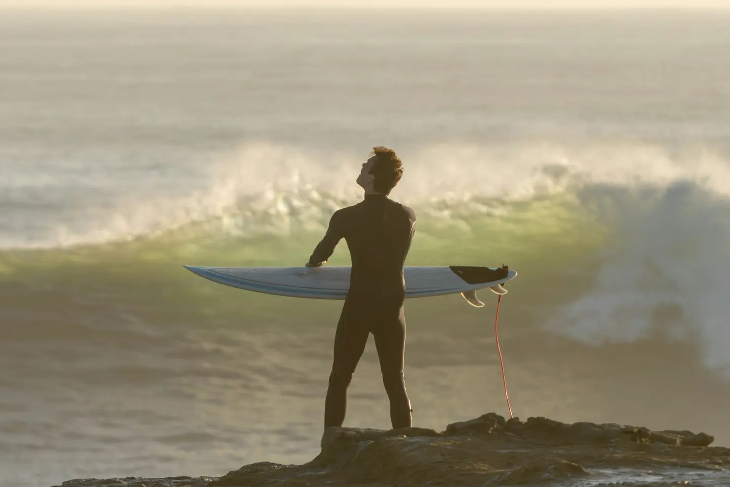 Surfer holding a board above the Santa Cruz coastline