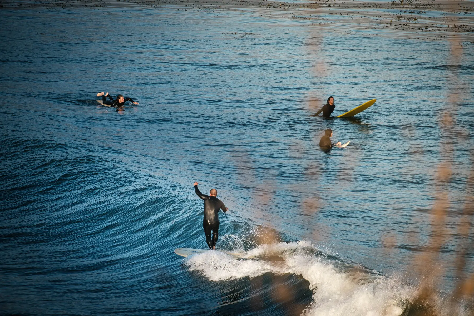 Surfers catching waves at The Hook in Santa Cruz