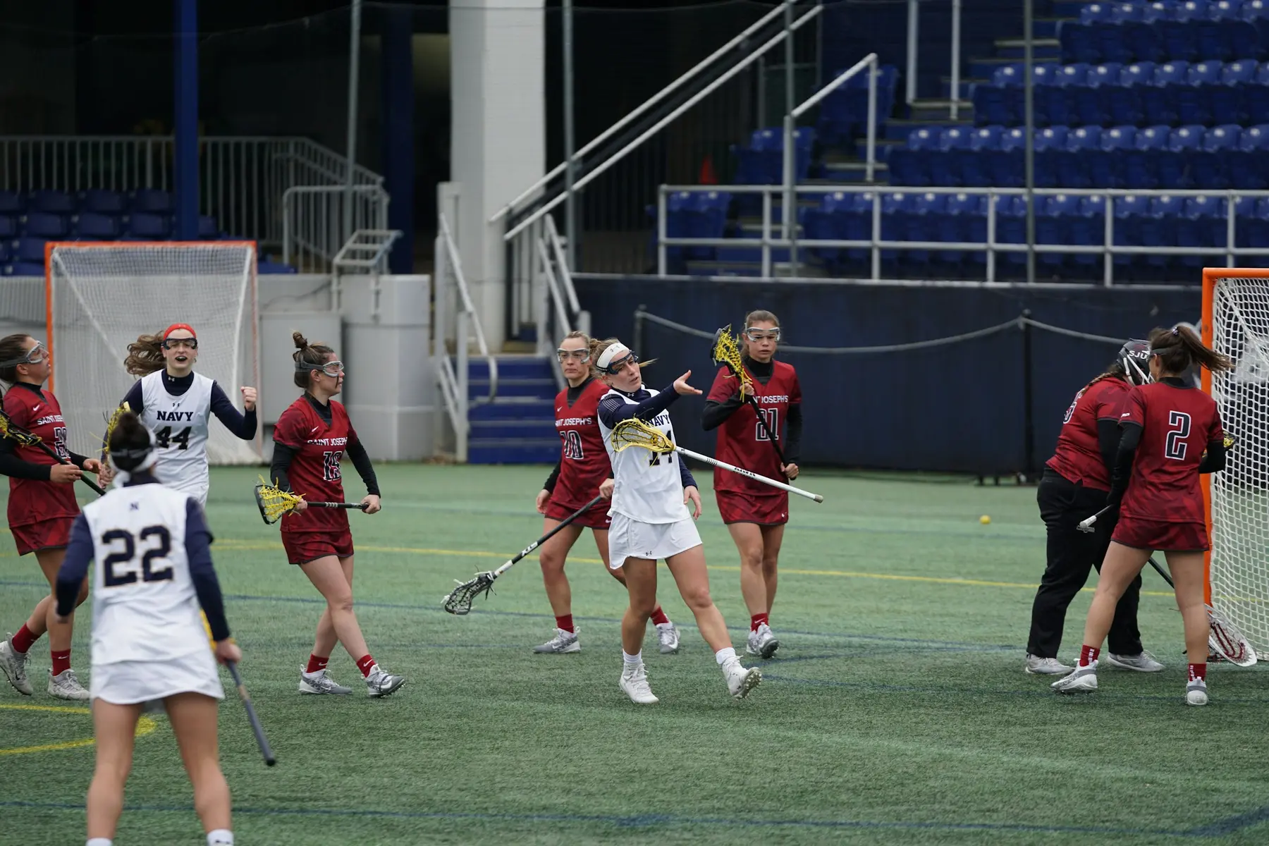 Women playing lacrosse during a competitive field match